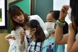 School children in South Korea are shown how to wear face masks to prevent the spread of the MERS virus