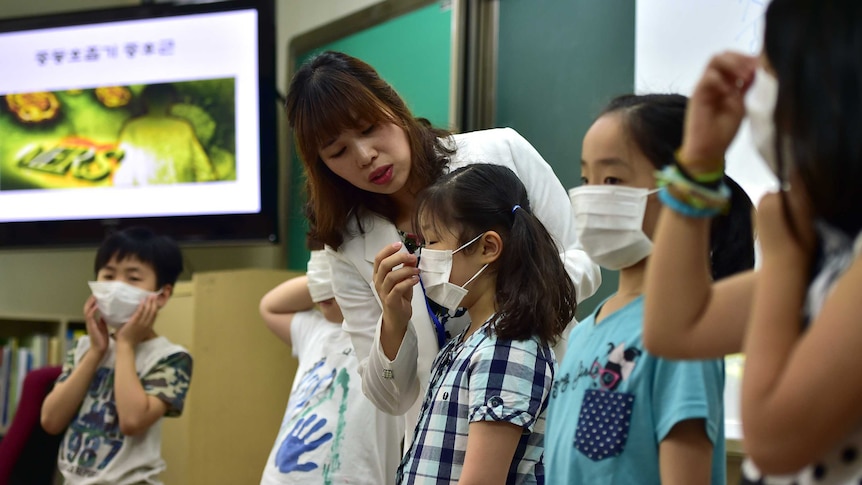 School children in South Korea are shown how to wear face masks to prevent the spread of the MERS virus