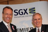 SGX and ASX CEOs (LtoR) Magnus Bocker and Robert Elstone shake hands on the merger between the two exchanges.