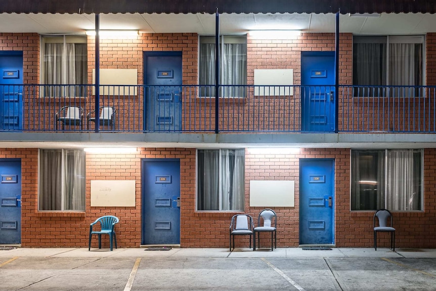 The front doors and windows of a budget motel.