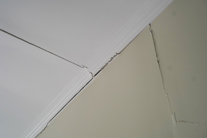 Cracks in the wall and roof of a house.