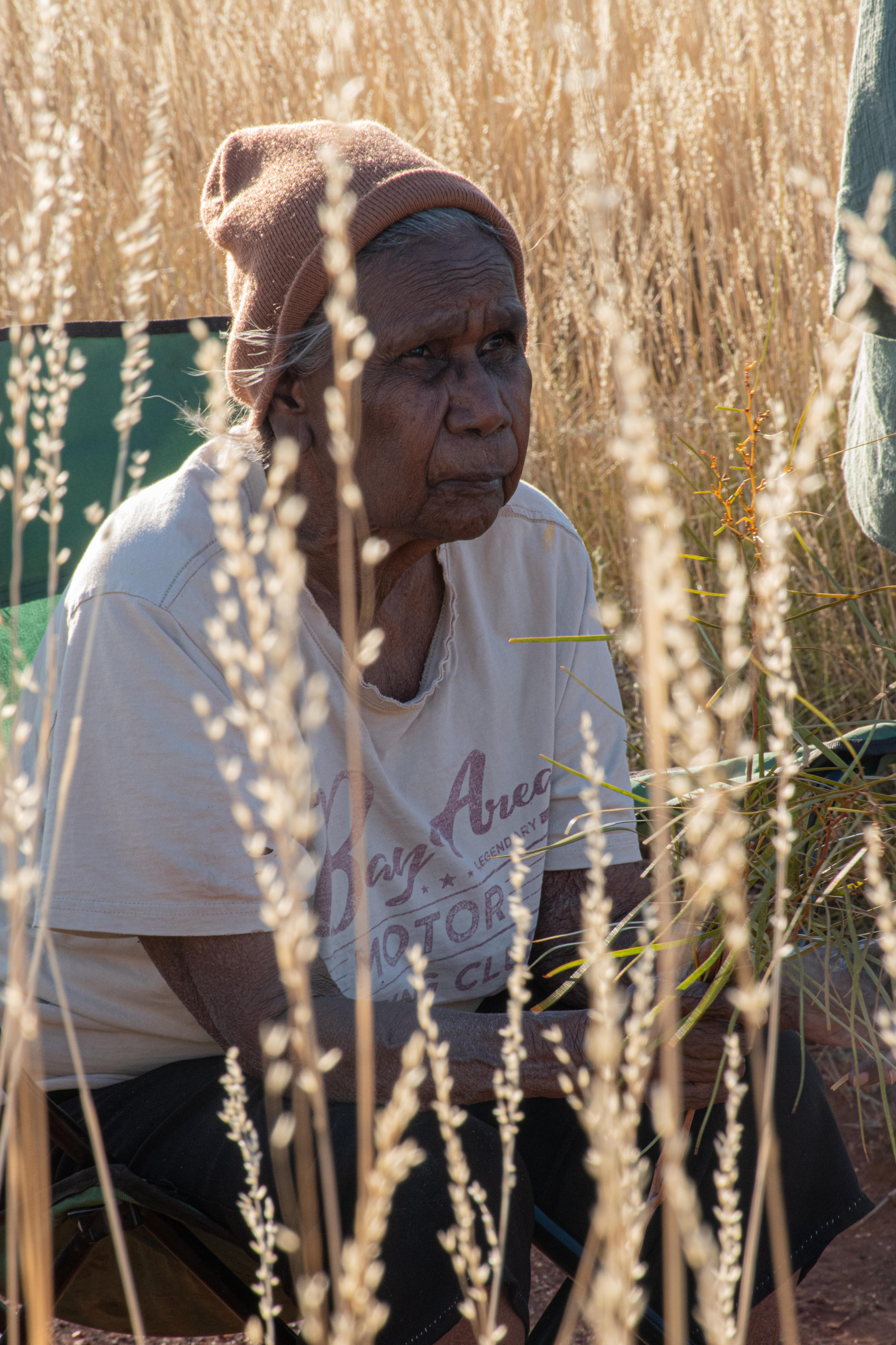 A close of woman sitting in a field