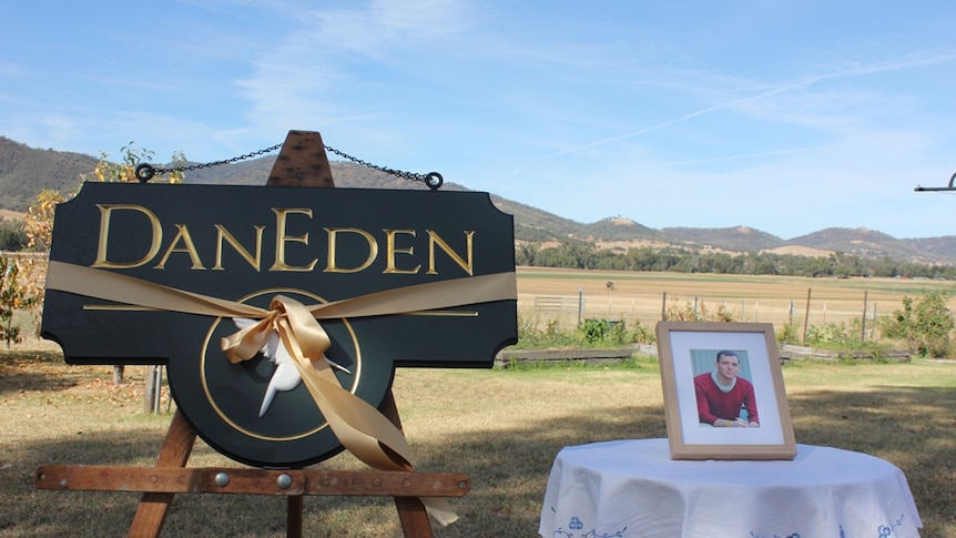 A photo of cancer sufferer and medicinal cannabis campaigner Dan Haslam sits beside a DanEden farm sign
