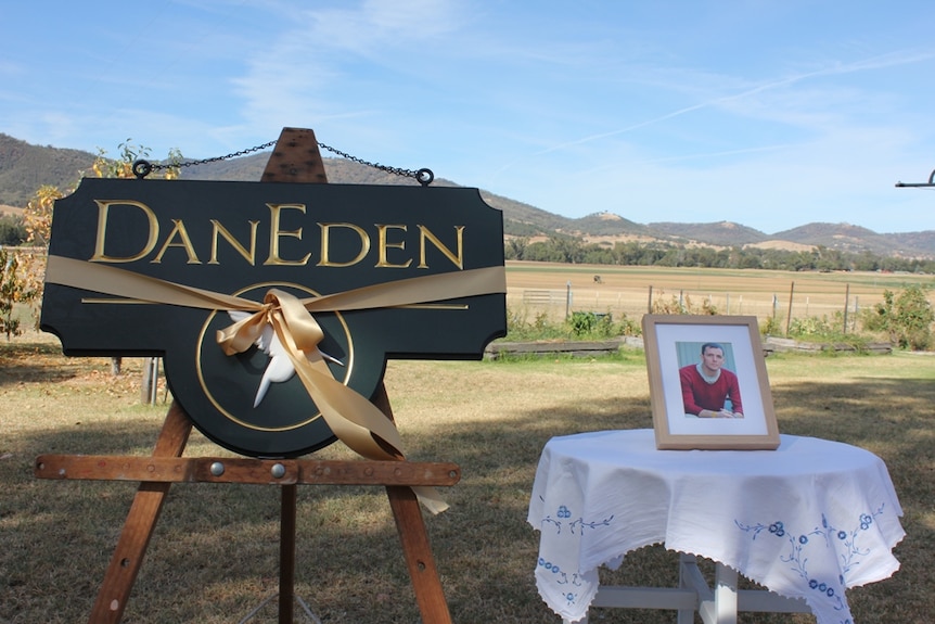 A photo of cancer sufferer and medicinal cannabis campaigner Dan Haslam sits beside a DanEden farm sign