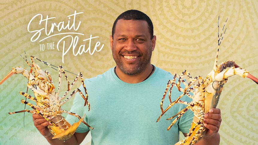 Man holding lobsters, one on each hand