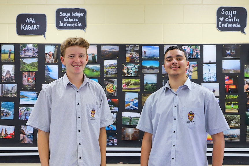 Two teenage boys look at the camera smiling