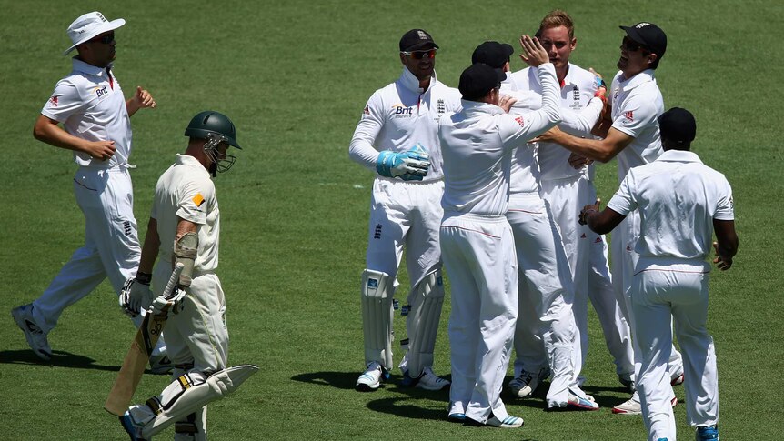 Stuart Broad of England is congratulated by team mates after dismissing Chris Rogers during day one of the First Ashes Test match between Australia and England at The Gabba on November 21, 2013 in Brisbane, Australia.