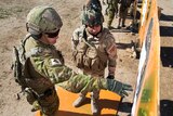 An Australian soldier trains an Iraqi soldier