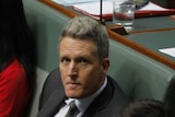 Josh Wilson sits in question time at parliament house