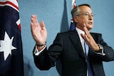 Treasurer Wayne Swan gestures during a news conference