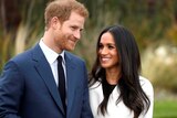 Prince Harry poses with Meghan Markle in the Sunken Garden of Kensington Palace.