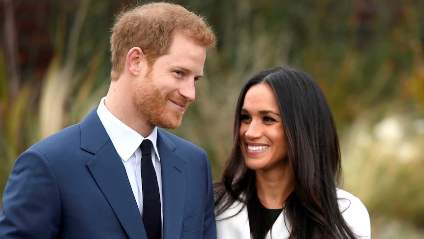 Prince Harry poses with Meghan Markle in the Sunken Garden of Kensington Palace.