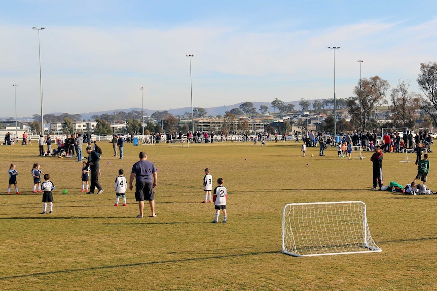 Children playing soccer at playing fields in Canberra.