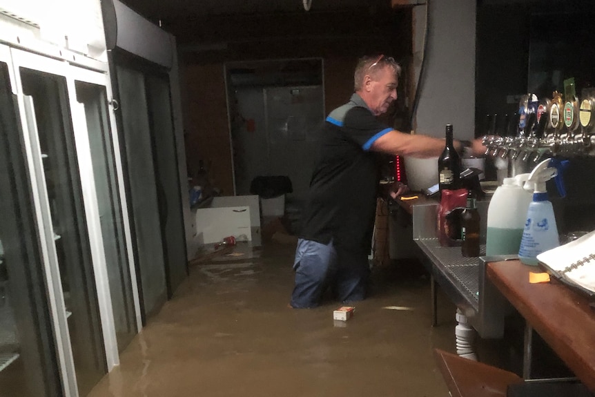 Man standing at the bar in the flooded sport and rec centre.