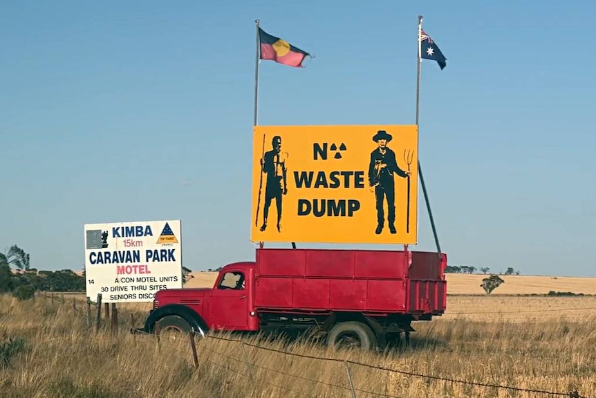 A no waste dump sign on the back of a truck in Kimba with an Aboriginal and Australian flag attached,