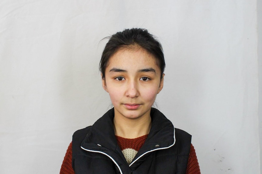 A mugshot of a young girl.
