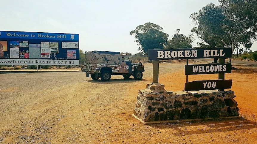 A Landrover sits parked behind the Broken Hill Welcomes You sign