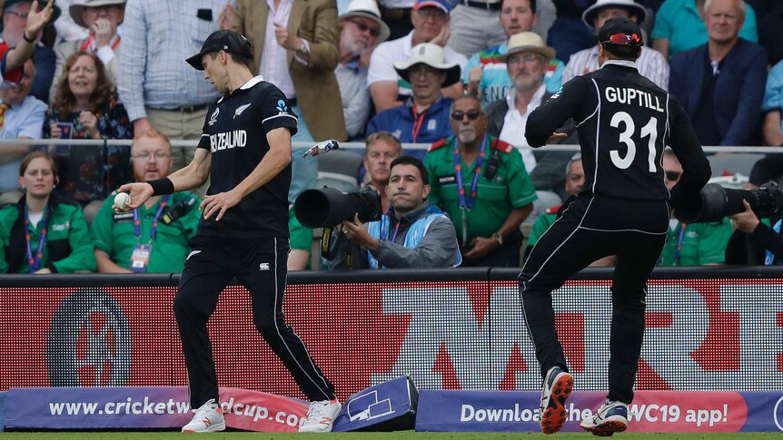 Trent Boult steps on the rope while taking a catch