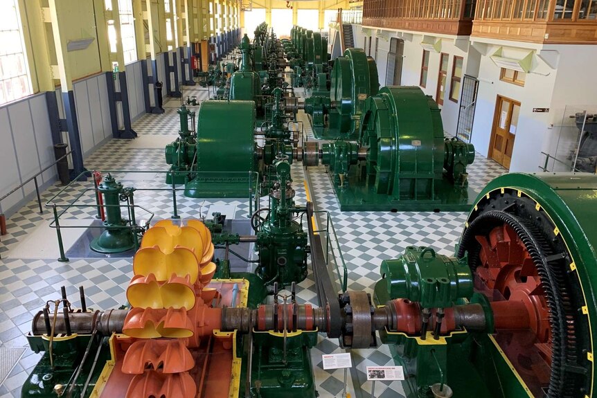 Hydro-electric power station generators inside an unused facility.