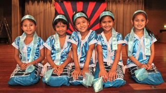 Young Karen dancers smiling to the camera