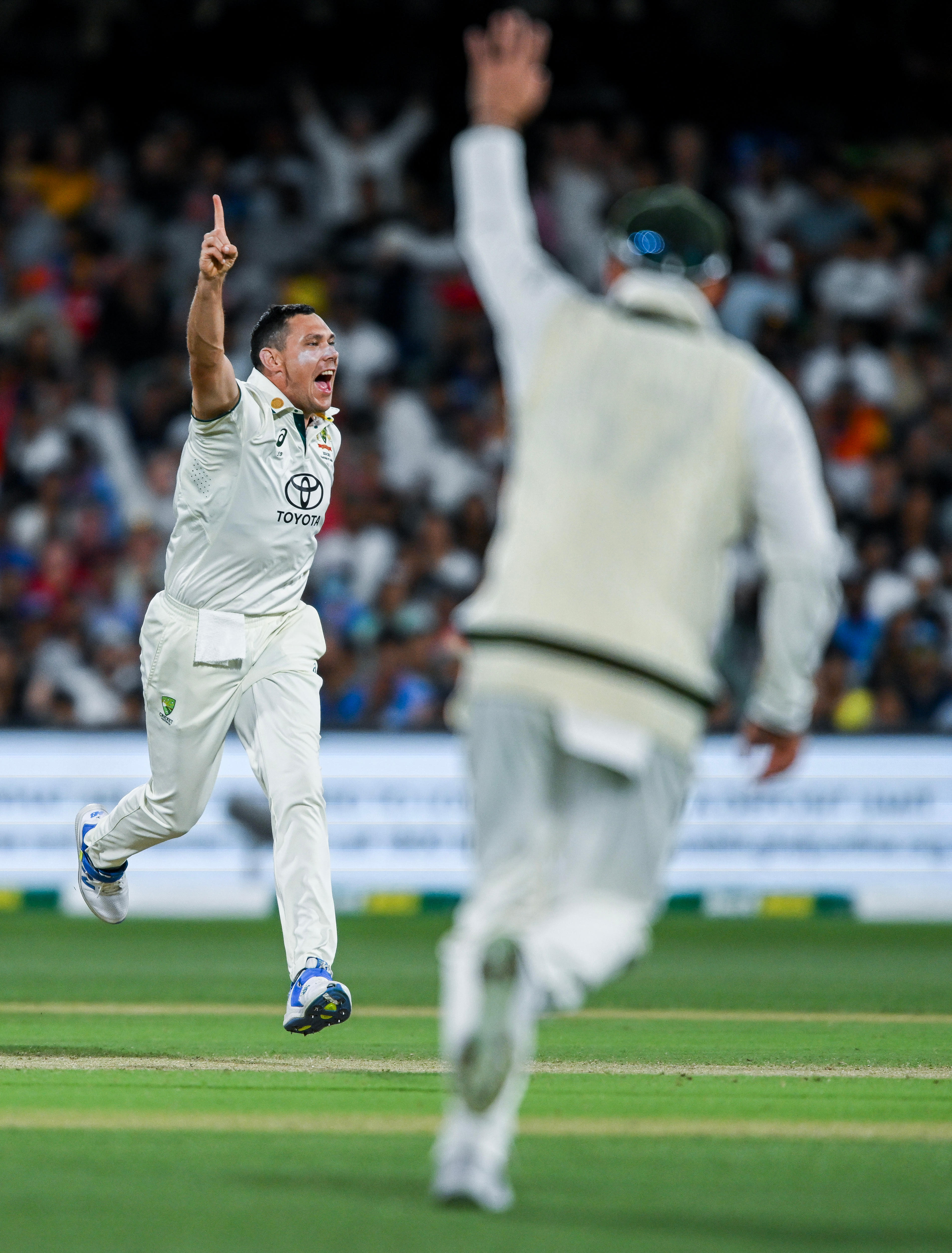 Australia bowler Scott Boland runs with his finger in the air during a Test against India.