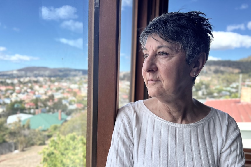 Brenda May looks out of the window at a panoramic view of Hobart.