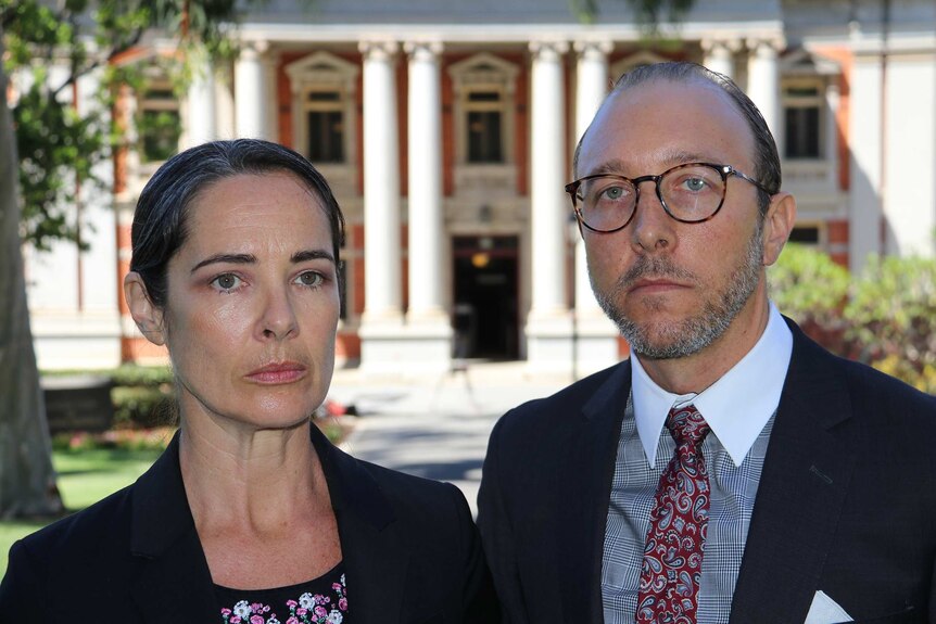 A close up of Catherine Atoms and Robert Cunningham standing outside the WA Supreme Court building.