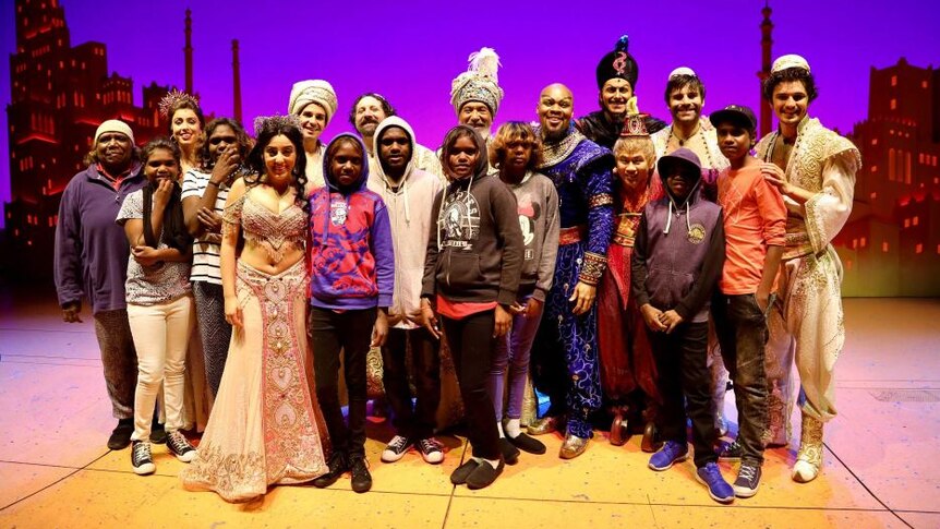 Students from the Ampilatwatja School in Alice Springs pose with the Melbourne cast of the musical Aladdin
