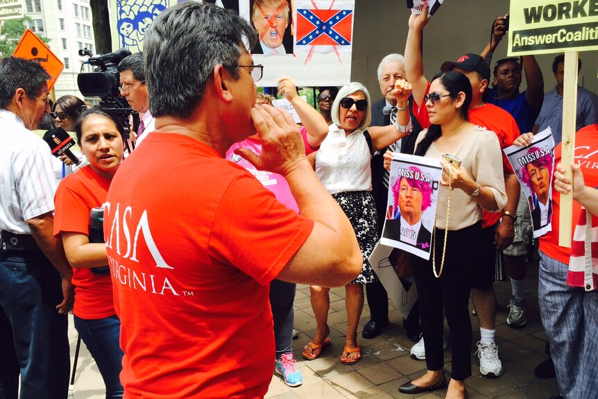 Immigrant groups and civil rights activists gather outside Trump Hotel.