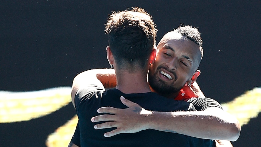 Two Australian male players embrace after they won a doubles match.