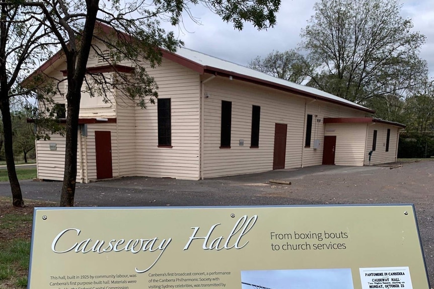 A simple wooden hall, with a sign in front reading 'Causeway Hall'