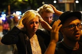 People leave the area with their hands up after an incident near London Bridge.