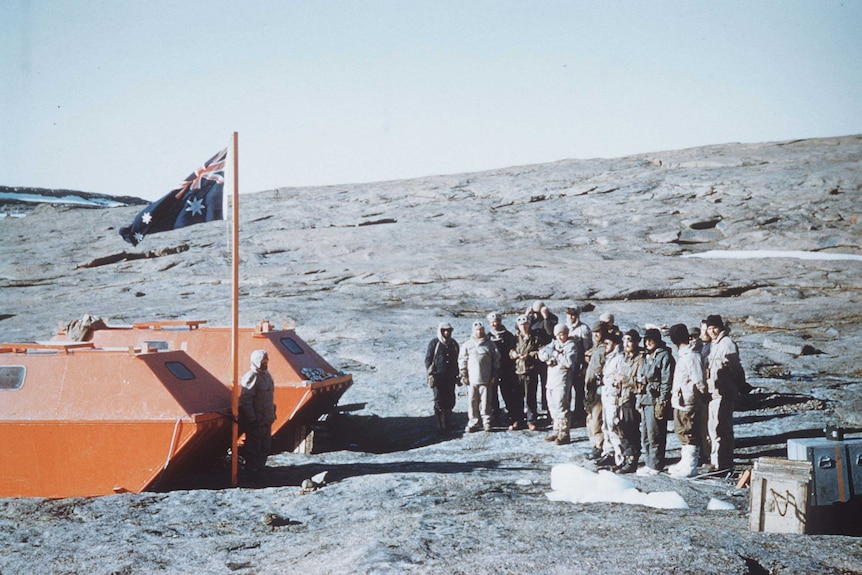 Picture of an Australian flag and a group of men