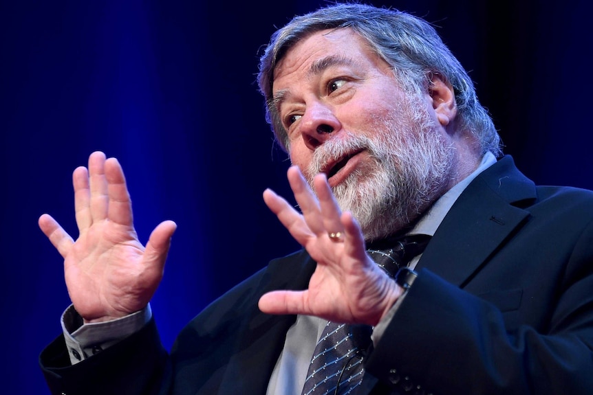 Steve Wozniak, a man with grey hair and a suit, talks at a product launch.