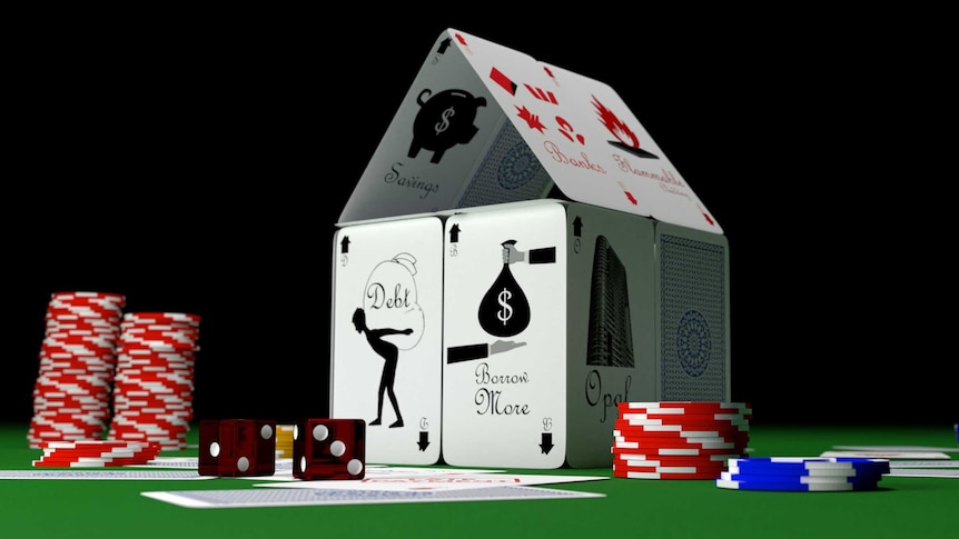 Image of a house made up of playing cards with gambling chips nearby.