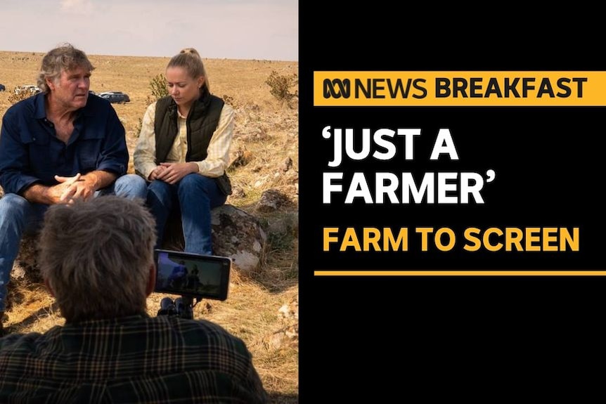 'Just A Farmer', Farm to Screen: A man and a woman sit down speaking while a camera operator films them.