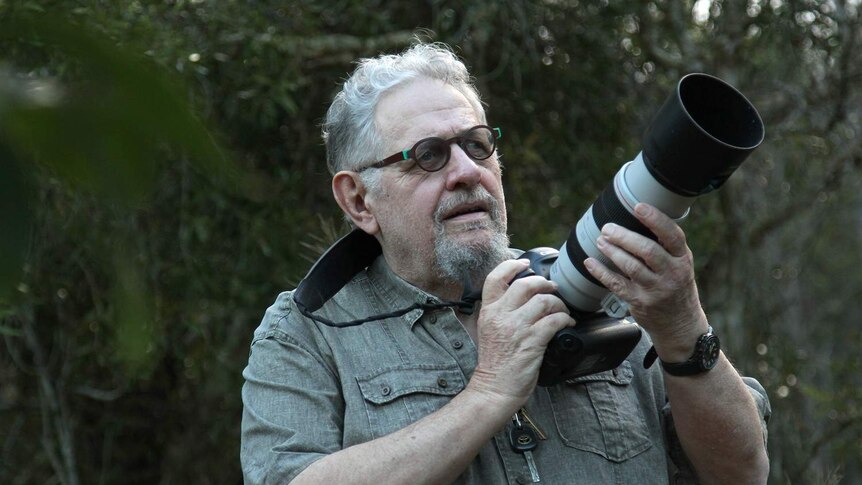 Wildlife Photographer Steve Parish holds a camera.