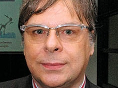 A head shot of Craig Peacock wearing glasses.