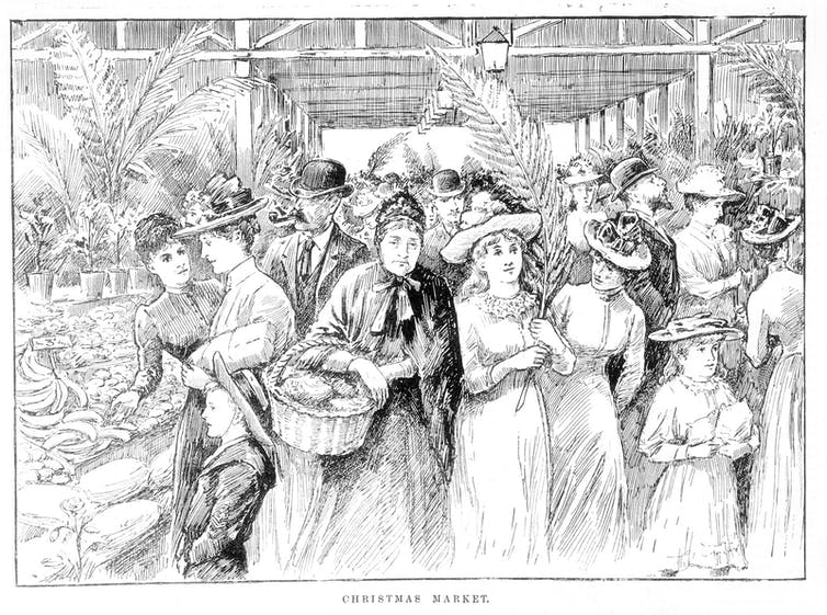 An illustration shows a crowd of people in traditional clothing shopping at an indoor market