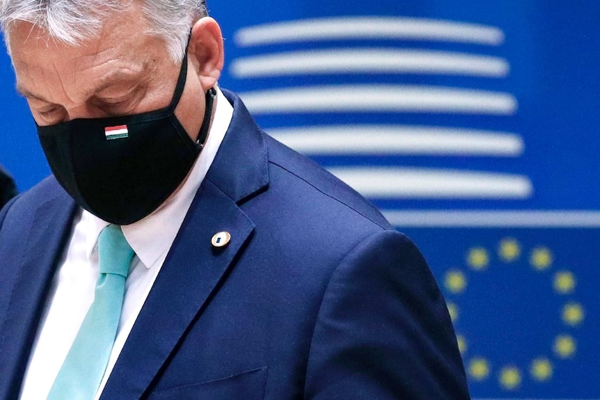 Hungary's Prime Minister Viktor Orban wears a protective face mask as he arrives for a round table meeting at an EU summit.