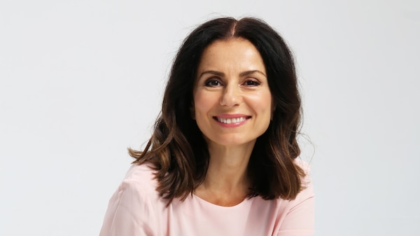 Mary Coustas sits to smile for the camera