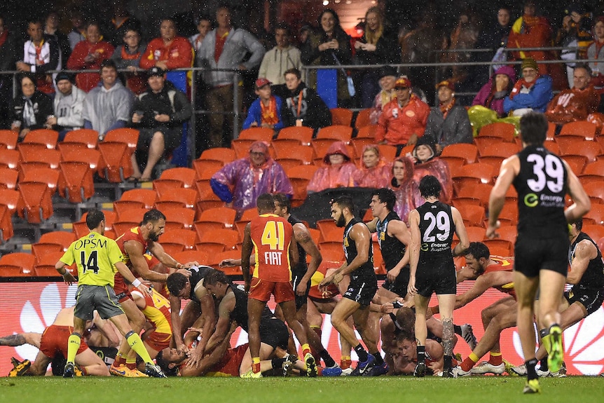 Gold Coast Suns and Port Adelaide Power players wrestle