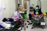 People rest on veld beds inside the emergency ward for the coronavirus patients