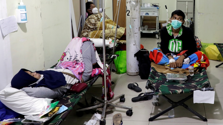 People rest on veld beds inside the emergency ward for the coronavirus patients