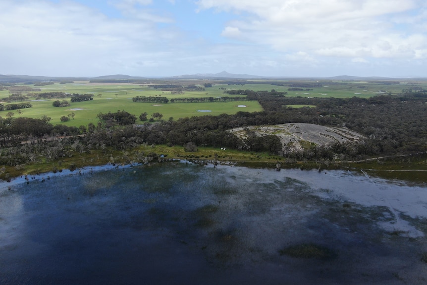 An aerial photo of a lake and granite outcrop