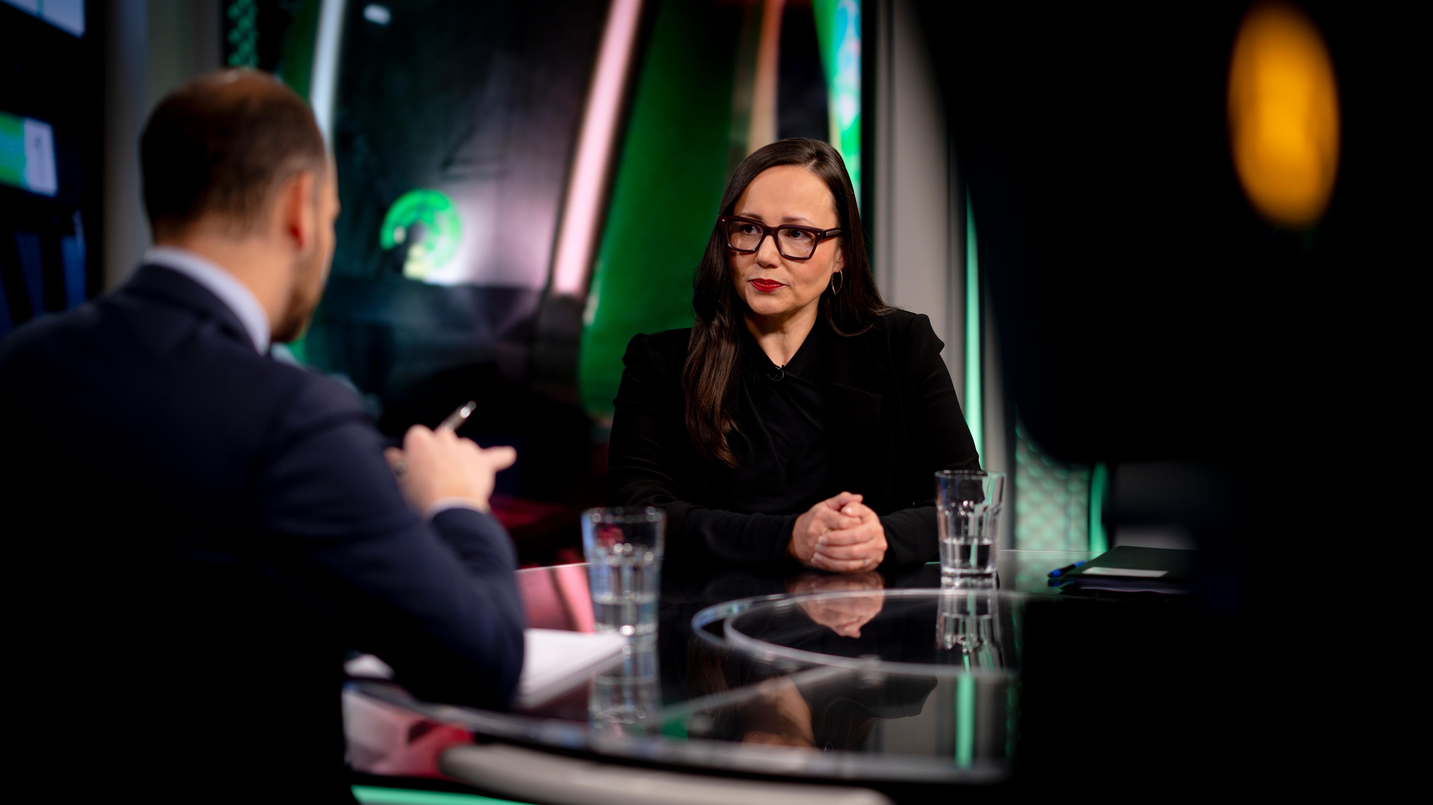 A female politician seated in a TV studio with an ABC reporter
