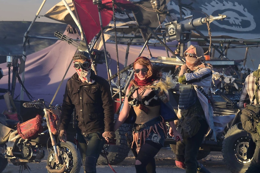 Festival goers arriving at sunset attend the first day of Wasteland Weekend in the high desert community of California City