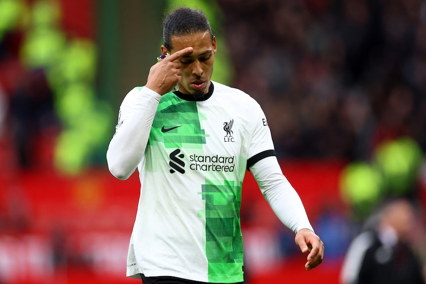 A soccer player, rubbing his brow in disappointment, during a drawn match in the English Premier League.