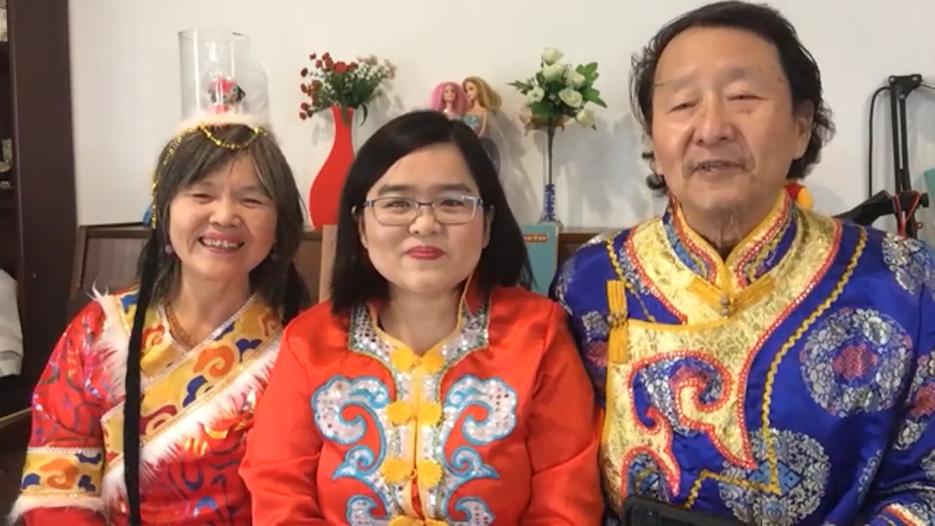 The Liu family dressed in traditional Manchu clothing sit in front of the family piano.