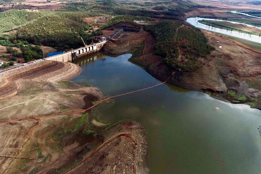 aerial view of keepit dam at less than 1 per cent capacity, the water is well below the dam wall.